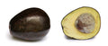 Fresh avocado, whole and halved showing the pit