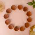 Set of 12 plain terracotta clay diya oil lamps arranged in a circle