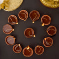 Set of 12 terracotta clay diya oil lamps filled with oil and wicks for Diwali puja