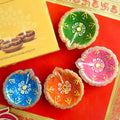 Set of 4 round hand-painted clay diya oil lamps for Diwali puja