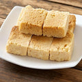 Milk cake burfi squares on a white plate