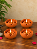 Set of 4 lotus-shaped terracotta diya oil lamps, lit